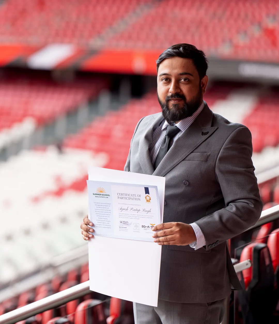 A past participant with his certificate at the stadium