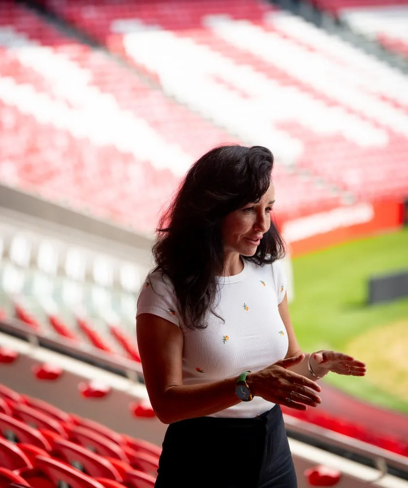 A speaker talking to participants at a stadium in Lisbon